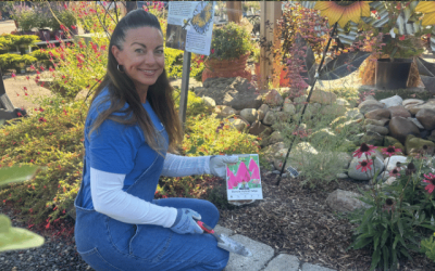Woman with bulbs and garden tool planting bulbs for spring color